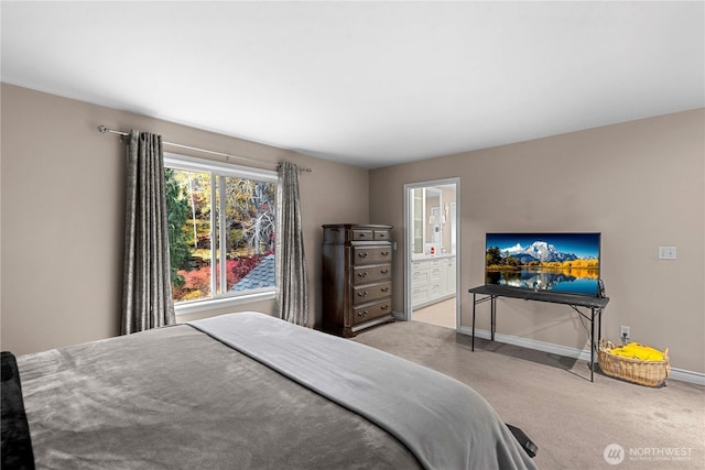 carpeted bedroom with baseboards and ensuite bathroom