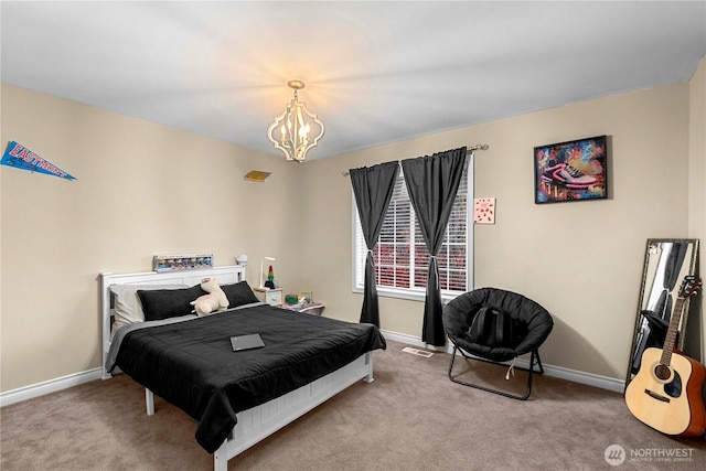 bedroom with baseboards, carpet flooring, and a chandelier