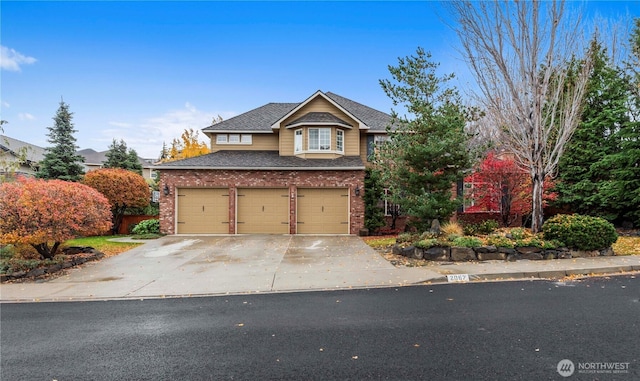 traditional-style home with a garage, a shingled roof, driveway, and brick siding