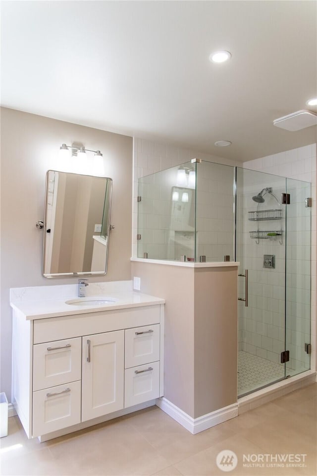 bathroom with vanity, tile patterned flooring, baseboards, recessed lighting, and a shower stall