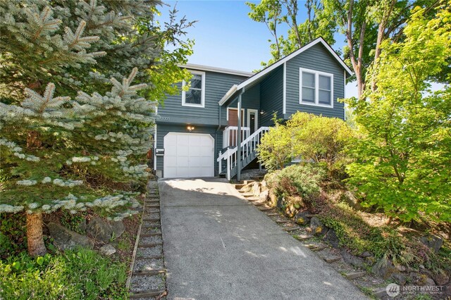 3003 E Pine St, Seattle, WA 98122 - view of front facade with concrete driveway and a garage