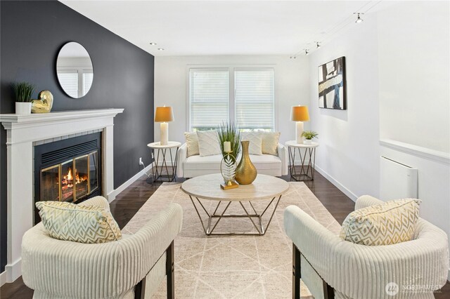 3003 E Pine St, Seattle, WA 98122 - living room featuring wood finished floors, a glass covered fireplace, baseboards, and track lighting