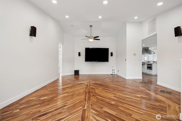 18 SE 18th St, Battle Ground, WA 98604 - unfurnished living room featuring wood finished floors, a ceiling fan, baseboards, recessed lighting, and high vaulted ceiling
