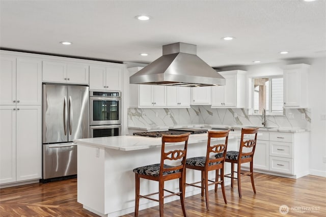 18 SE 18th St, Battle Ground, WA 98604 - kitchen with stainless steel appliances, island range hood, a sink, decorative backsplash, and recessed lighting