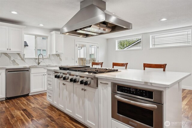 18 SE 18th St, Battle Ground, WA 98604 - kitchen with appliances with stainless steel finishes, island range hood, dark wood finished floors, recessed lighting, and a center island