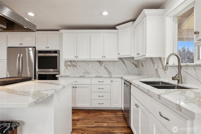 18 SE 18th St, Battle Ground, WA 98604 - kitchen featuring appliances with stainless steel finishes, a sink, white cabinets, wall chimney exhaust hood, and recessed lighting