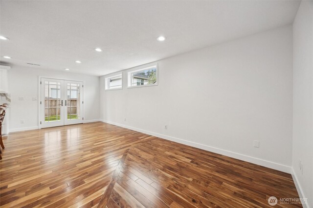 18 SE 18th St, Battle Ground, WA 98604 - unfurnished living room with recessed lighting, baseboards, light wood finished floors, and french doors
