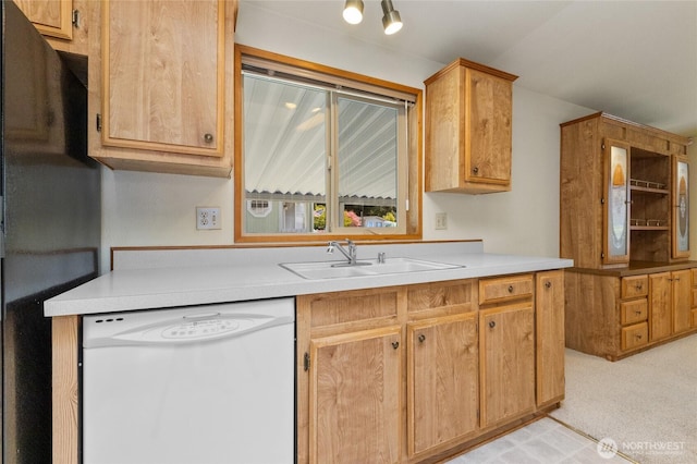 kitchen featuring freestanding refrigerator, light colored carpet, light countertops, a sink, and dishwasher
