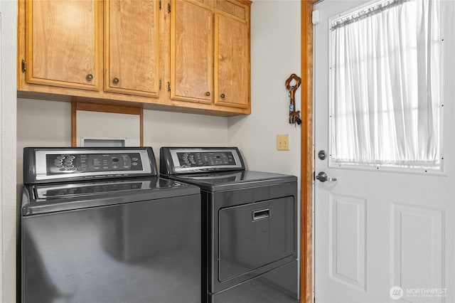 washroom featuring cabinet space and washing machine and dryer