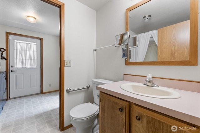 full bathroom with vanity, toilet, tile patterned floors, a shower with shower curtain, and baseboards