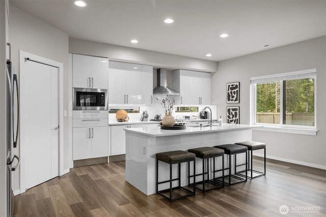 33455 Holly Ave SE, Black Diamond, WA 98010 - kitchen with a sink, a breakfast bar area, built in microwave, wall chimney exhaust hood, and freestanding refrigerator