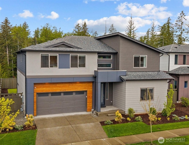33455 Holly Ave SE, Black Diamond, WA 98010 - contemporary home featuring fence, stucco siding, a shingled roof, an attached garage, and driveway