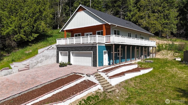 15941 Glenwood Rd SW, Port Orchard, WA 98367 - view of front of property featuring board and batten siding, a front yard, decorative driveway, and a forest view