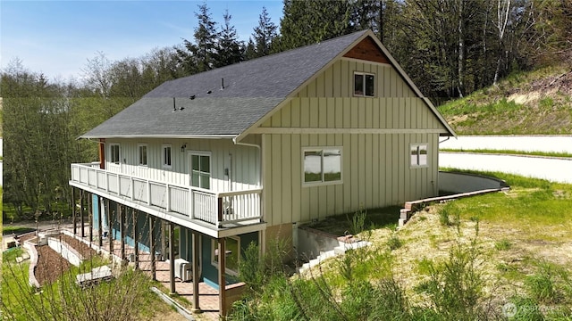 15941 Glenwood Rd SW, Port Orchard, WA 98367 - rear view of property featuring board and batten siding, a wooden deck, and roof with shingles
