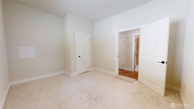15941 Glenwood Rd SW, Port Orchard, WA 98367 - unfurnished bedroom with baseboards and light carpet
