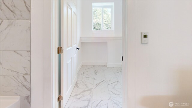 15941 Glenwood Rd SW, Port Orchard, WA 98367 - bathroom featuring a bathing tub, baseboards, and marble finish floor
