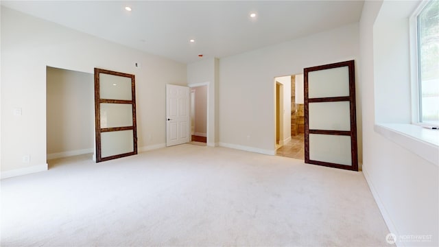 15941 Glenwood Rd SW, Port Orchard, WA 98367 - unfurnished bedroom with recessed lighting, baseboards, light carpet, and multiple windows