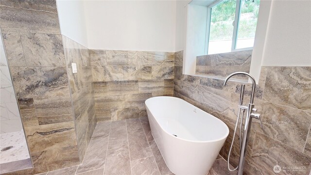15941 Glenwood Rd SW, Port Orchard, WA 98367 - bathroom featuring tiled shower, tile walls, a soaking tub, and a wainscoted wall