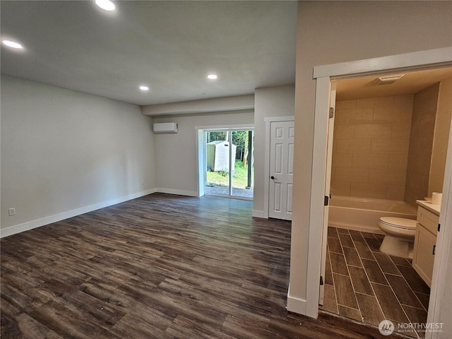 15941 Glenwood Rd SW, Port Orchard, WA 98367 - interior space with a wall mounted air conditioner, wood finished floors, baseboards, toilet, and recessed lighting