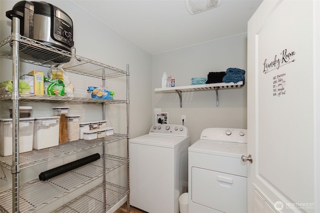 washroom featuring laundry area, independent washer and dryer, and wood finished floors