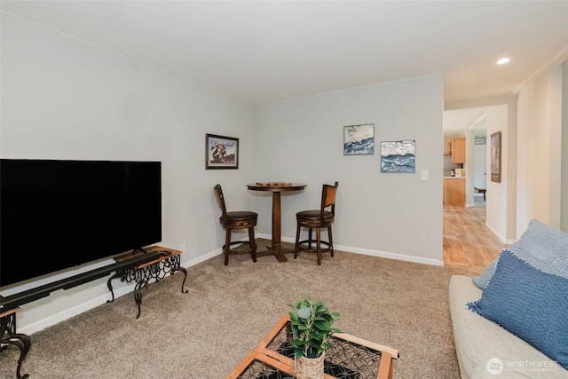 living room with baseboards and carpet