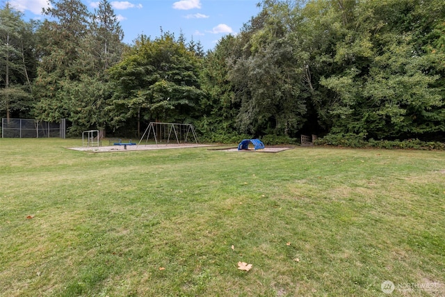 view of yard featuring fence and a playground