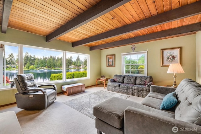 living area with carpet, beam ceiling, and wooden ceiling