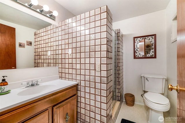 bathroom with toilet, walk in shower, and vanity