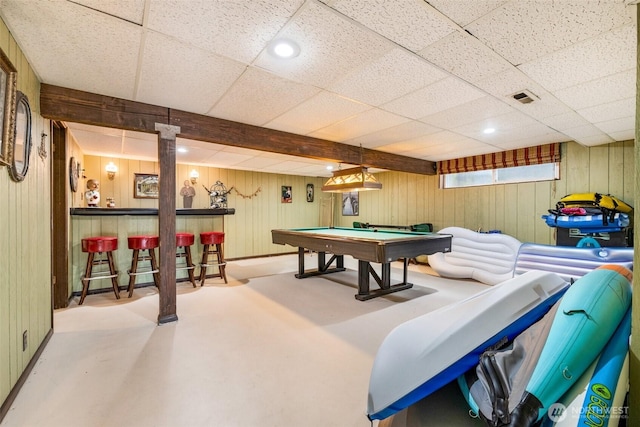game room featuring billiards, visible vents, a dry bar, wood walls, and concrete floors