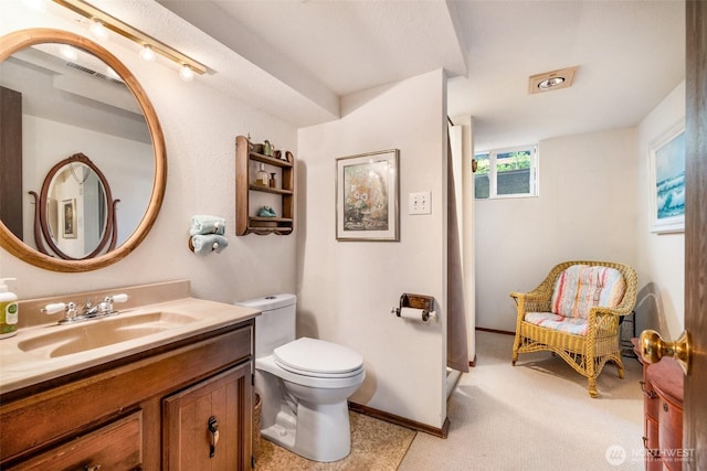 bathroom with vanity, a shower, and toilet