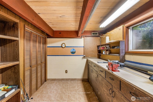 interior space featuring visible vents, tile patterned floors, and wooden ceiling