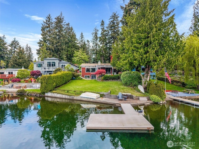 view of dock featuring a water view and a yard
