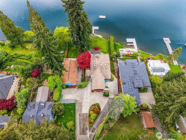 birds eye view of property with a water view and a residential view