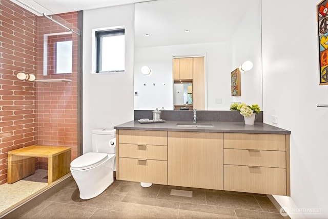 1721 J B George Rd, Walla Walla, WA 99362 - full bathroom featuring a tile shower, toilet, vanity, and tile patterned flooring