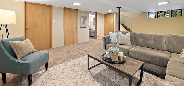 carpeted living area with stairway