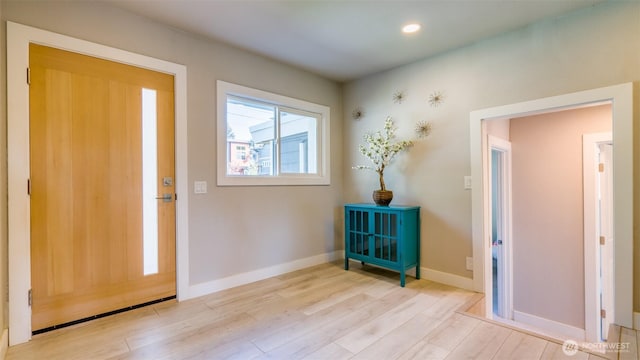 foyer entrance featuring baseboards, recessed lighting, and wood finished floors