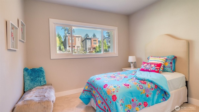 bedroom with baseboards and carpet