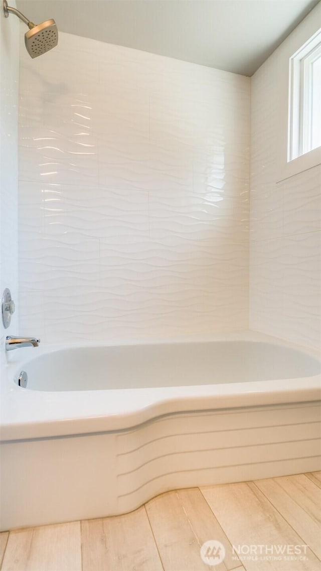 bathroom featuring shower / tub combination and wood finished floors