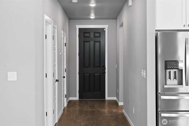 interior space with baseboards and dark wood finished floors