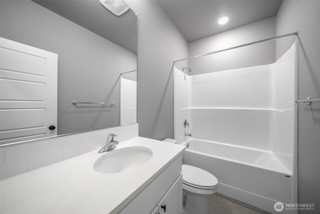 bathroom with recessed lighting, vanity, toilet, and tub / shower combination