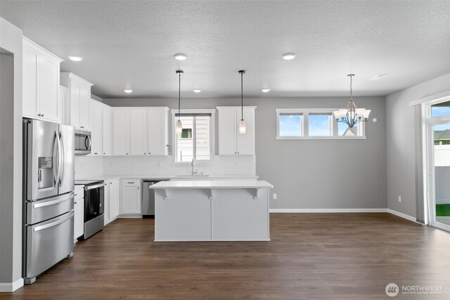 kitchen featuring light countertops, a sink, white cabinetry, and stainless steel appliances