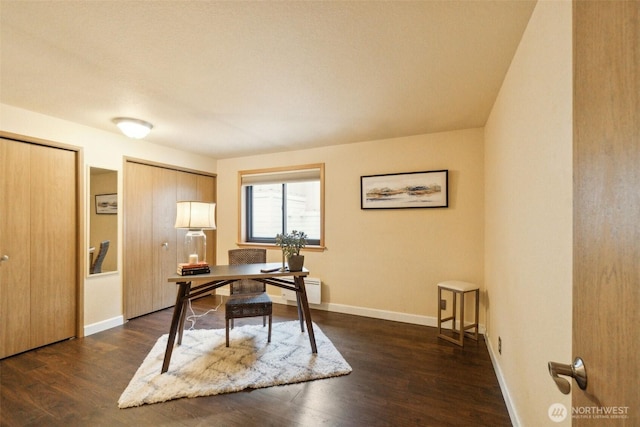 office area with baseboards and dark wood finished floors