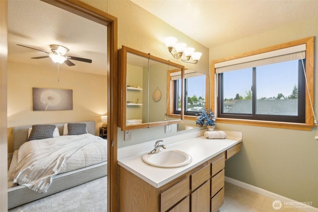 bathroom with vanity, a ceiling fan, and baseboards