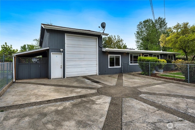 view of front of property featuring fence and concrete driveway