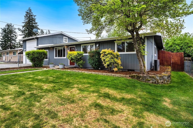 view of front of house with an attached garage and central AC