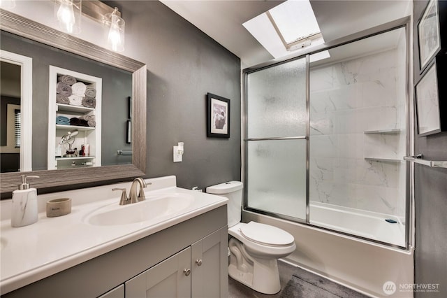 full bath with a skylight, vanity, toilet, and enclosed tub / shower combo