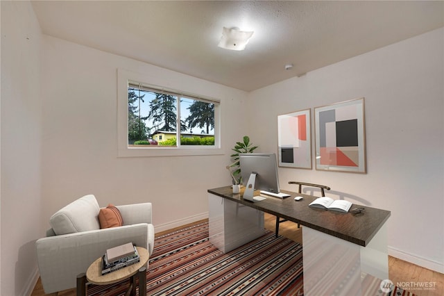 home office featuring baseboards and light wood-style flooring