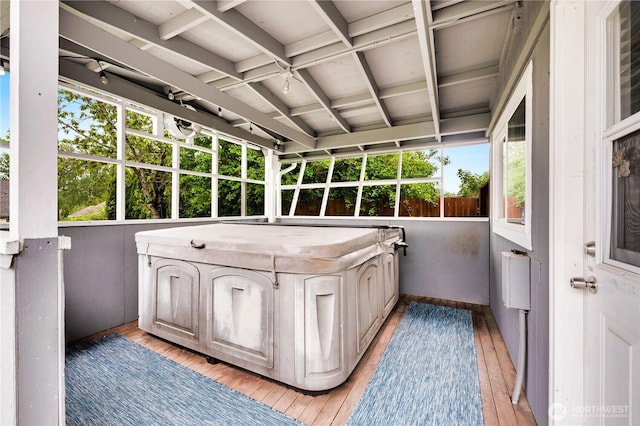 unfurnished sunroom with a hot tub and plenty of natural light