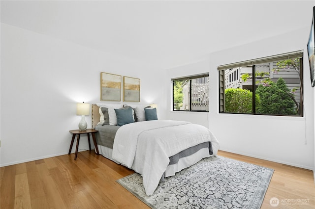 bedroom featuring baseboards and light wood-type flooring