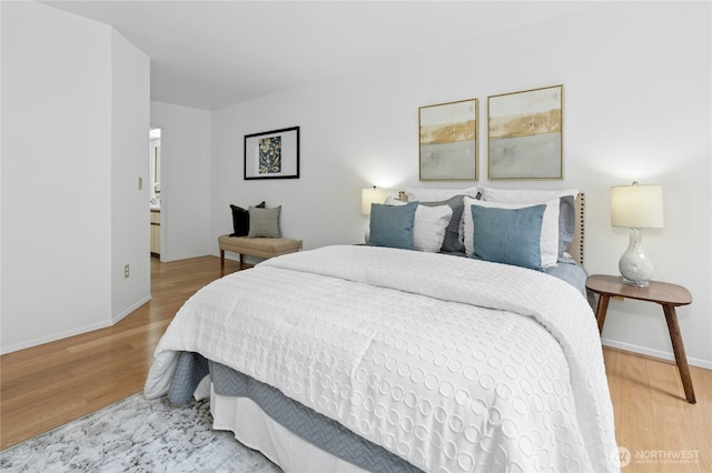 bedroom with baseboards and wood finished floors